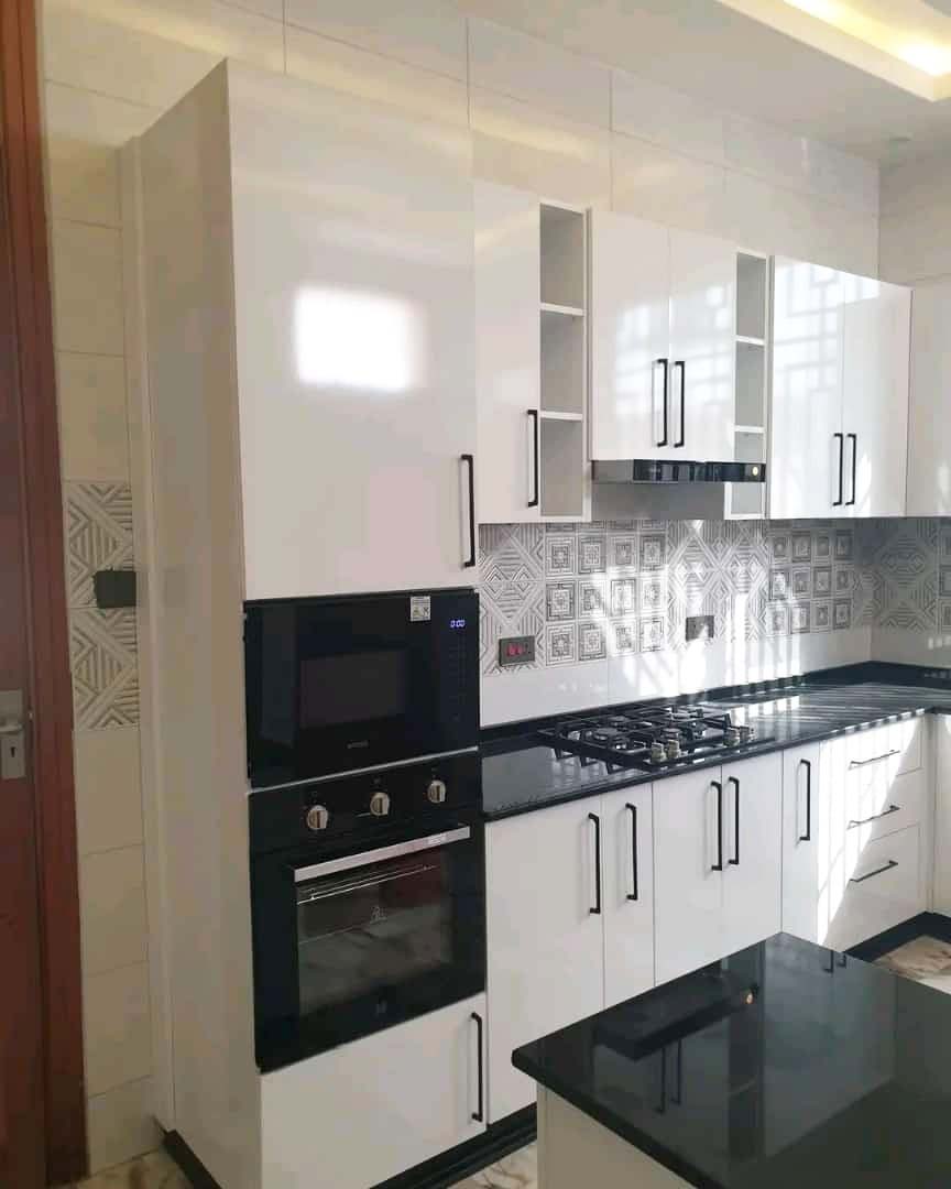 Kitchen cabinets design in Kampala Uganda. Wood cabinets installation. Trust Interiors Uganda. Leading interior design company in Uganda. Services: Interior design services, installation services, manufacturing of modern stylish furniture products in Uganda, East Africa. ugabox.com