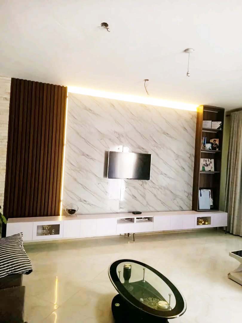 TV unit design in Kampala Uganda. Stylish modern wood TV wall unit installation in Uganda. Trust Interiors Uganda. Leading interior design company in Uganda. Services: Interior design services, installation services, manufacturing of modern stylish furniture products in Uganda, East Africa. ugabox.com