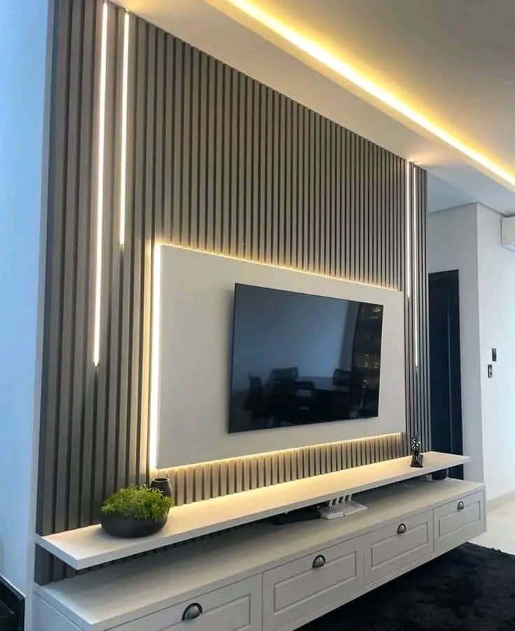 TV unit design in Kampala Uganda. Stylish modern wood TV wall unit installation in Uganda. Trust Interiors Uganda. Leading interior design company in Uganda. Services: Interior design services, installation services, manufacturing of modern stylish furniture products in Uganda, East Africa. ugabox.com